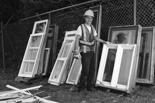 Builders skip being loaded with construction waste in Stoke Newington