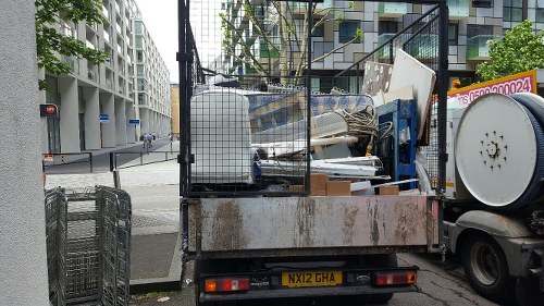 Professional loading waste into a skip in Stoke Newington